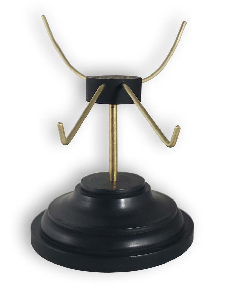 Skull stand with black base and brass tines front view.